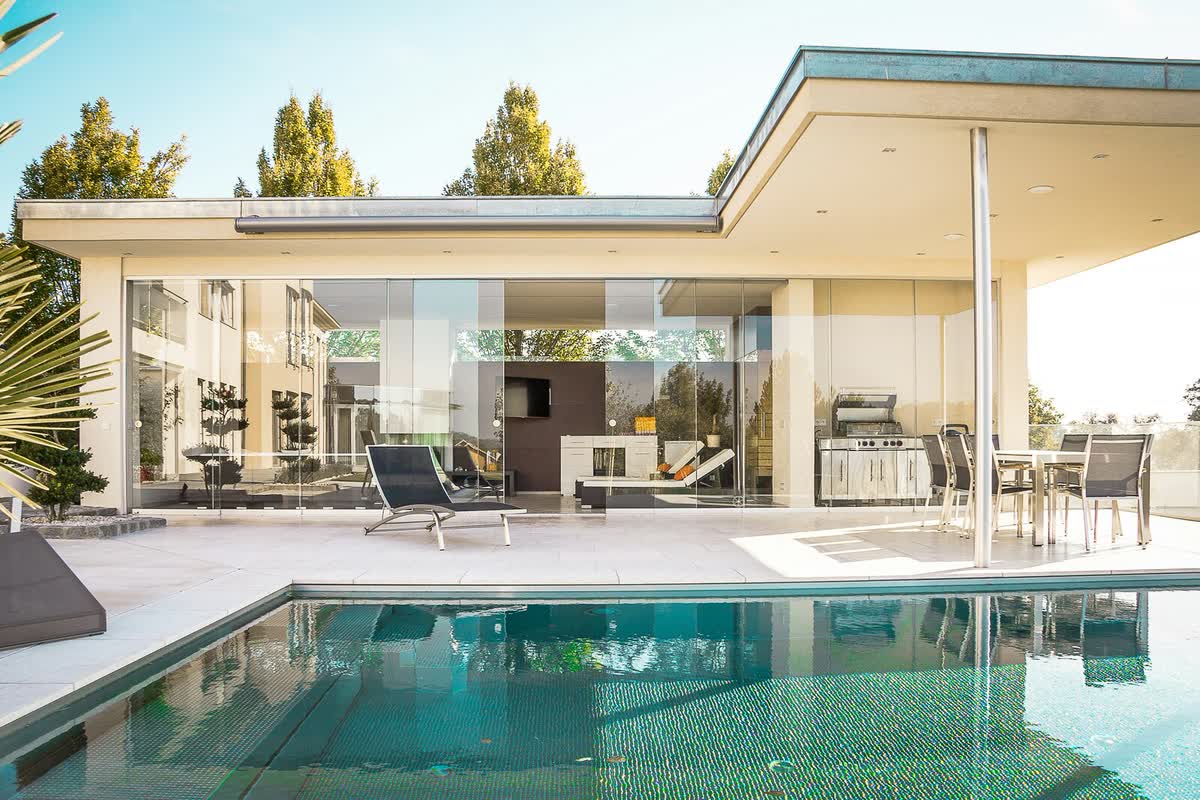 Clear blue pool beside a modern home